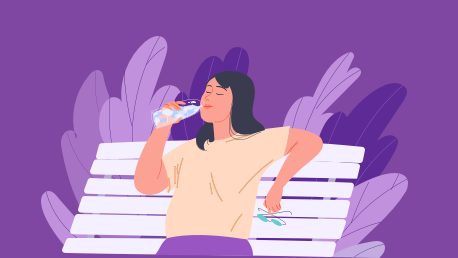 Woman drinking water on a park bench